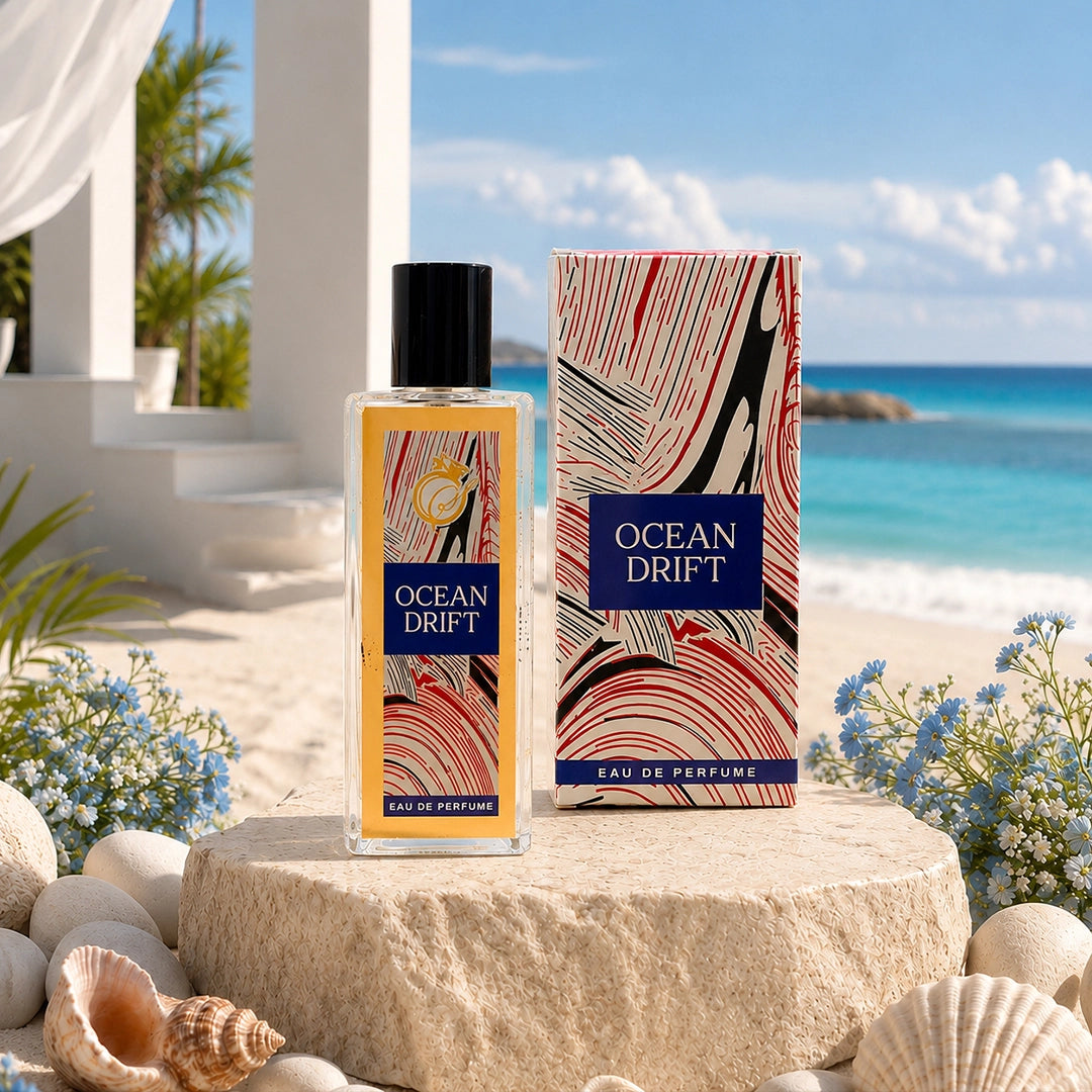Ocean Drift Eau De Perfume 50ml in a clear glass bottle with an artistic gift box displayed in a beachside setting with seashells.